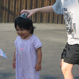 Little Angie is crowned by Dante with a plastic hat