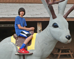 Arthur sitting on a Jackalope at Wall Drug