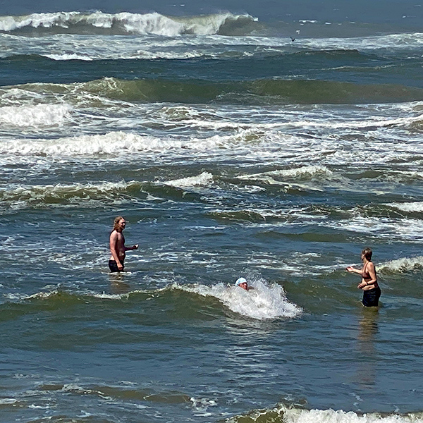 Dante, Eric, and Jennell in the ocean.