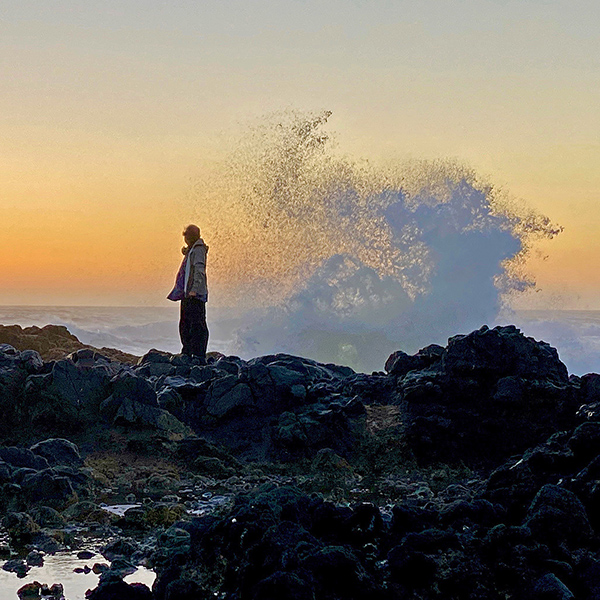 Eric standing on a rock at sunset.