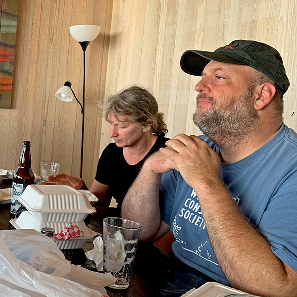 Mom, Jennell, and Jason sitting down for a meal in our Yachats house.