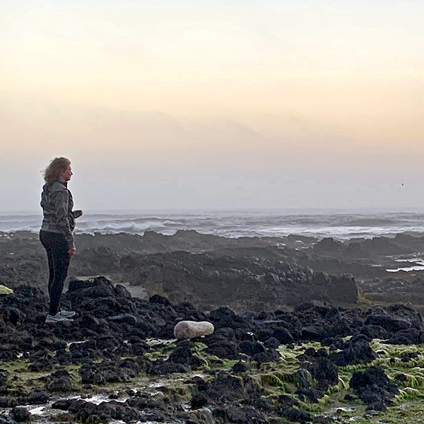Jennell looking out to sea on the rocks at Yachats.