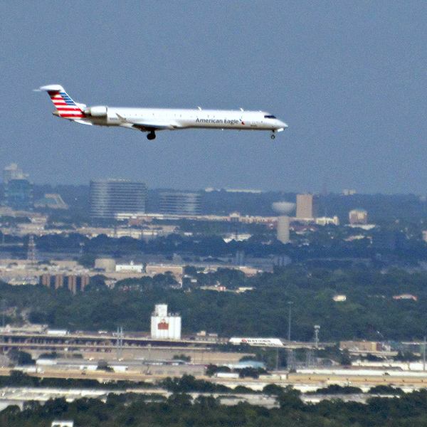 Arriving in Dallas we make our descent, and out my window I see another airplane landing with us.