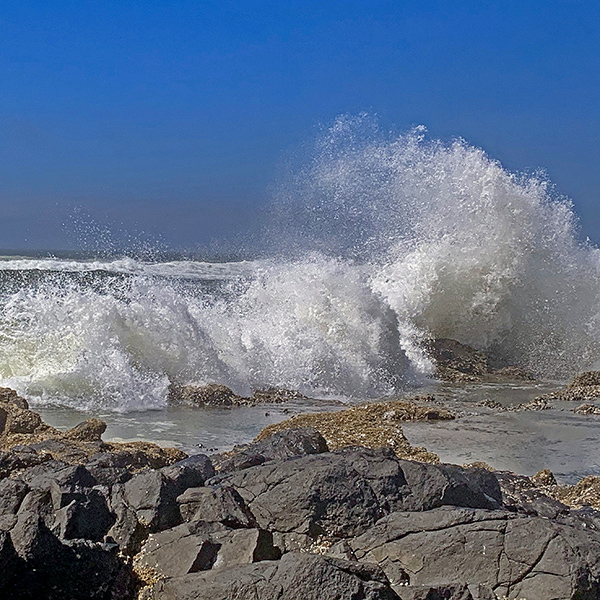 I love to watch the waves crash and spray into the air.