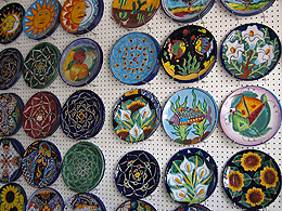 Colorful Pottery hanging on a wall.