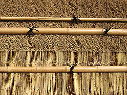 Woven grasses and bamboo make a pattern on the wall