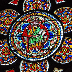Christ wears yellow and green, and sits on a throne.
