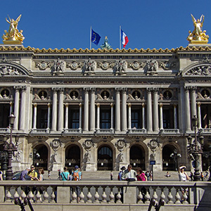 The facade of the Paris Opera looms up over the stairs descending to the Opéra metro station. 