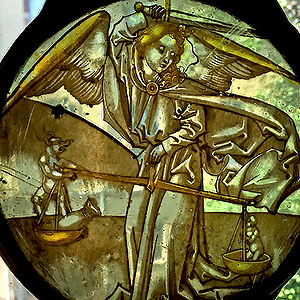 Weighing the worth of a soul Saint Michael weighs the merit and sin of a soul, holding a balance scale in his left hand and raising his sword with his right arm.