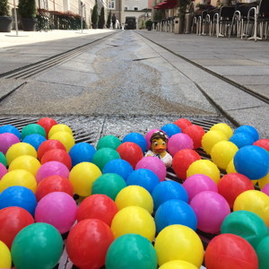  Colorful plastic balls floating down the street. There's even a duck!