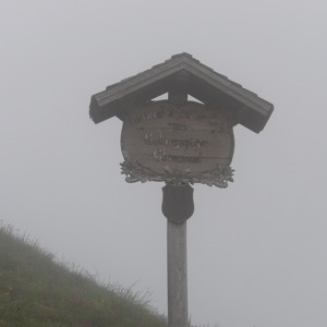 A cute sign with a roof at top of the Untersberg mountain. 