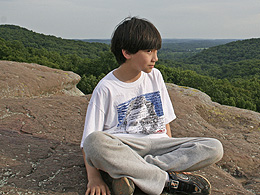 Arthur sitting at the top of the cliff.