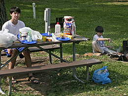 Sebastian sitting at a picnic table.