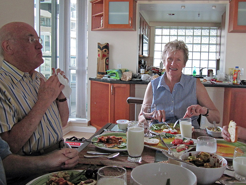 The family sits at a table and people are eating delicious food