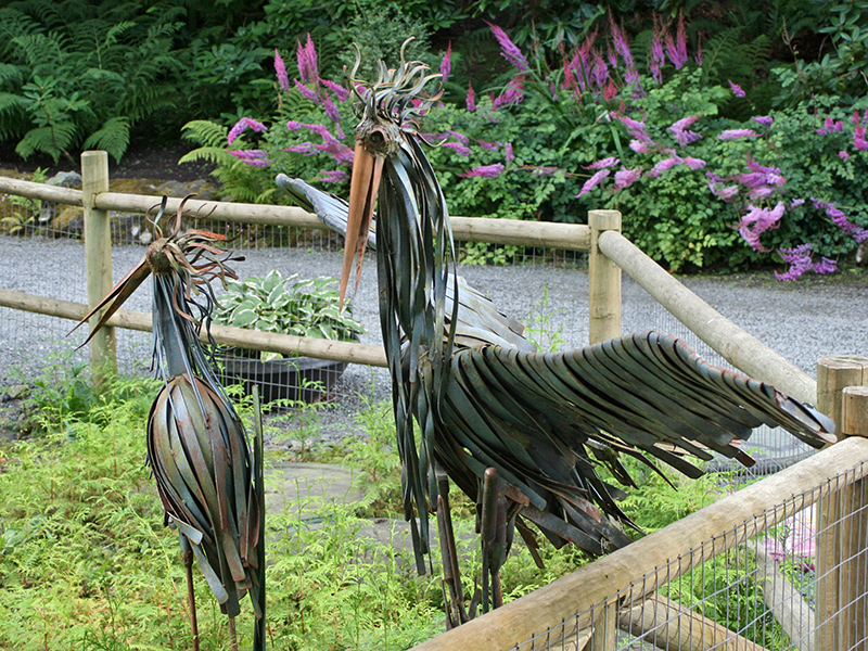 Two heron or crane birds have been made as sculptures using strips of metal