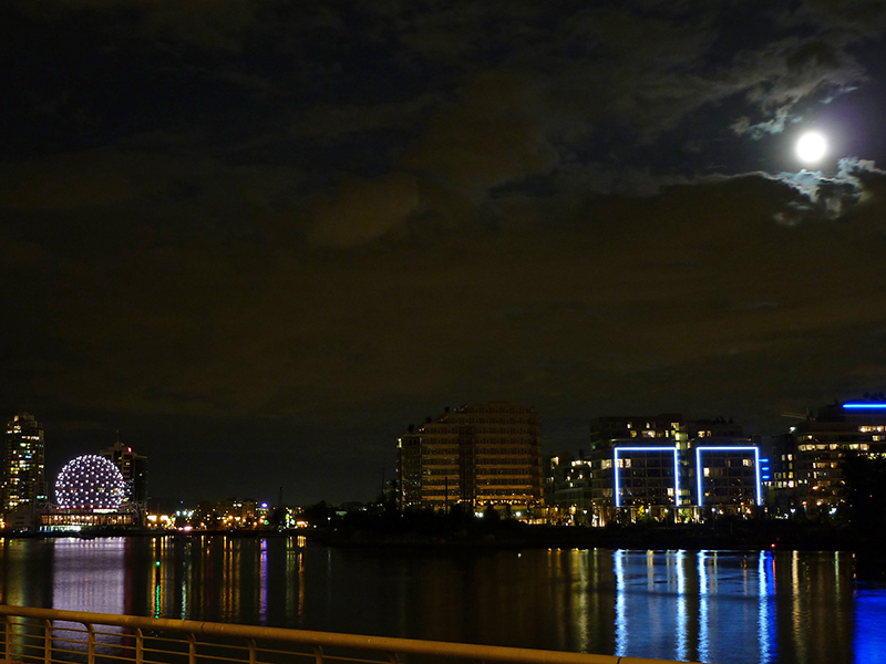 A view of the Vancouver Science Center and lights reflected on False Creek bay