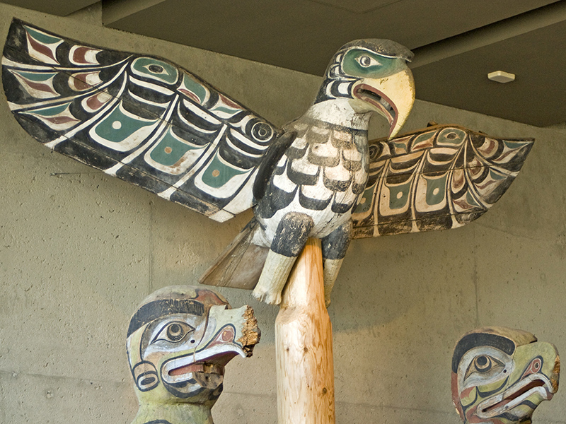 Kwakwaka’wakw eagle sitting on top of a pole 