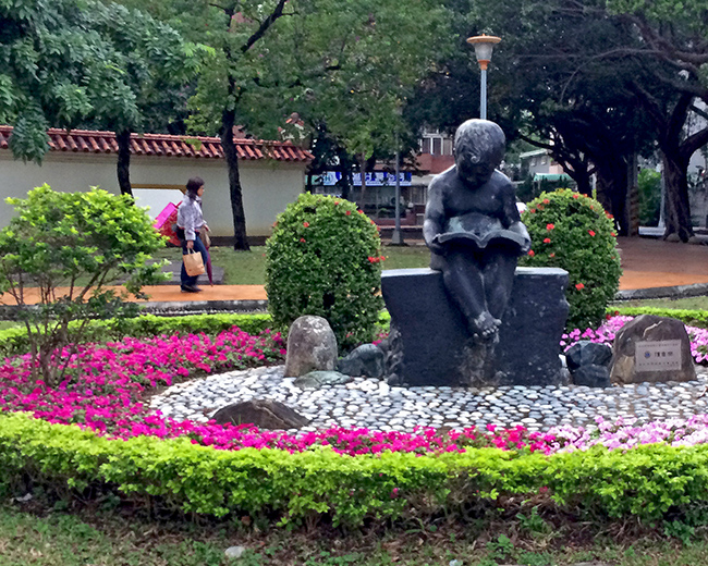 Statue of child reading a book