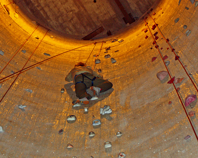 Eric climbing up silo in Upper Limits