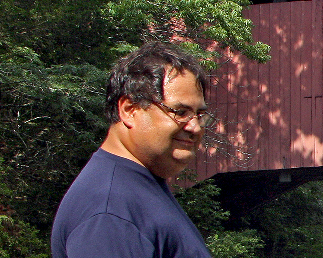 Robert in front of covered bridge
