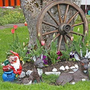 Yard decorations in Gimmelwald, with such ornaments as a dwarf (from Snow White and the Seven Dwarfs), foxes, deer, and a wagon wheel.