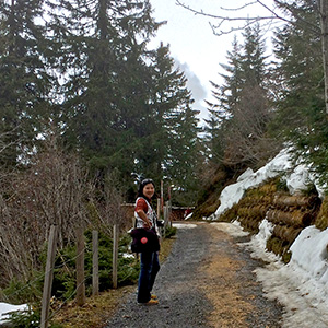 Jeri is walking on a trail with snow around her