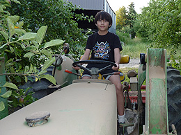 A ten-year-old boy driving a tractor.