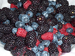 A pile of blackberries, blueberries, and raspberries