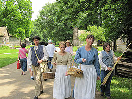 Young people aged 12-15 walking down a street in an 1830s village