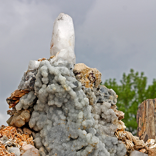 A large white hunk of crystal atop a dome of rocks and crystals