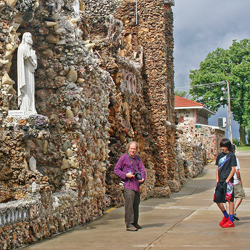 People looking at the grotto’s rocks and statues.