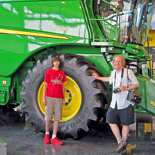 Arthur stands in front of a wheel that is about six feet in diameter, about the same as his height.