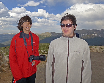 Boys seem happy on top of mountain