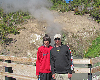 Boys posing in front of steaming hole