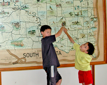 Boys pointing at a map
