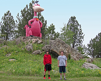 Boys posing with Flintstone dinosaur