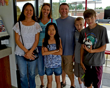 Happy families in ice cream stand