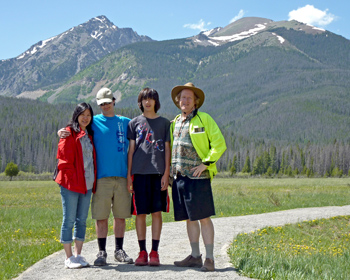 Family posing in valley with mountains behind us