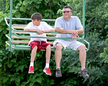Father and son on ski lift ride