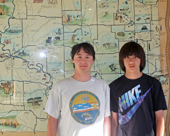 Boys standing in front of a map