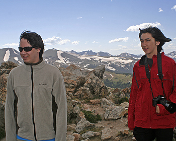 Wind blowing on boys on top mountain