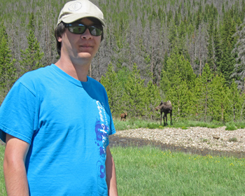 Sebastian with a moose and moose calf behind him