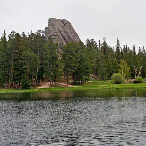 A lake with odd massive rocks around it.