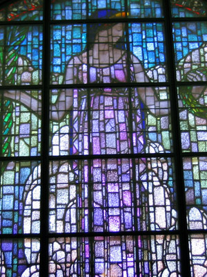 Grant Hart designed window of woman holding wreath in blues and purples, done as a war memorial in Cedar Rapids
