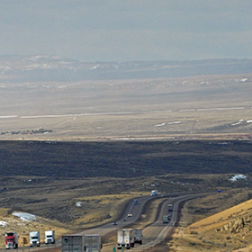The road stretches ever on across the Wyoming plains.