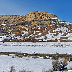 The ground is covered mostly with snow and sagebrush around Fossil Butte.