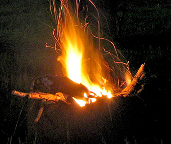 A modern example of controlled fire; a fire in a campground fire pit.