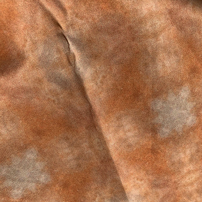 Sunlight shines on some fabric I designed ; this fabric is made from a scan of a polished stone, and I call it Small Quartzite Pebble