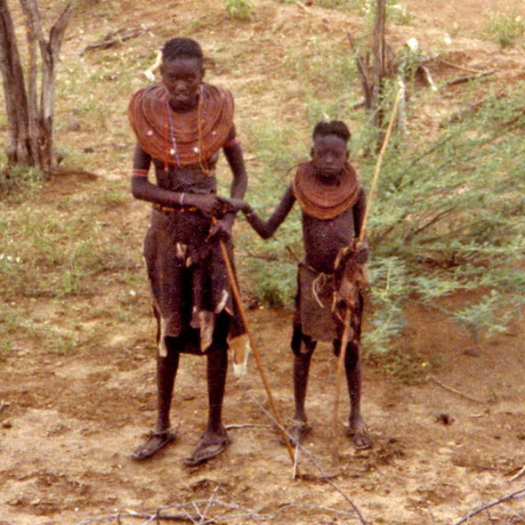 A Pokot woman with a girl stop to say hello