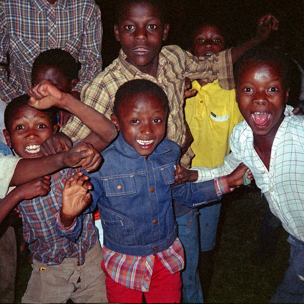 Children laughing and playing around on the lower slopes of Kilimanjaro